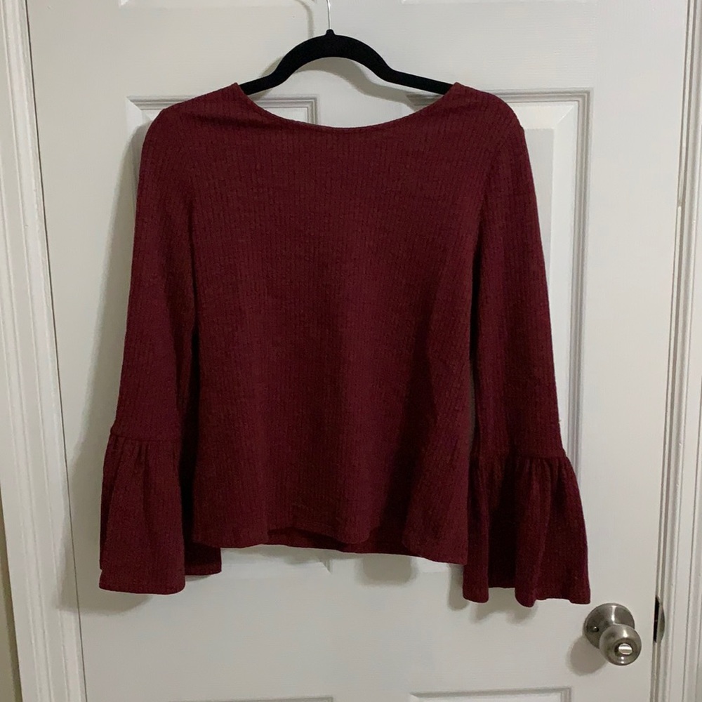 Maroon top with bell sleeves, line detailing